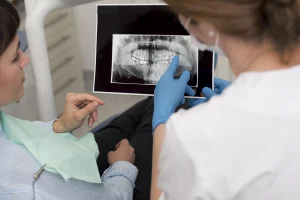 Female patient examining her dental tomography with the dentist – Mecidiyeköy dental tomography